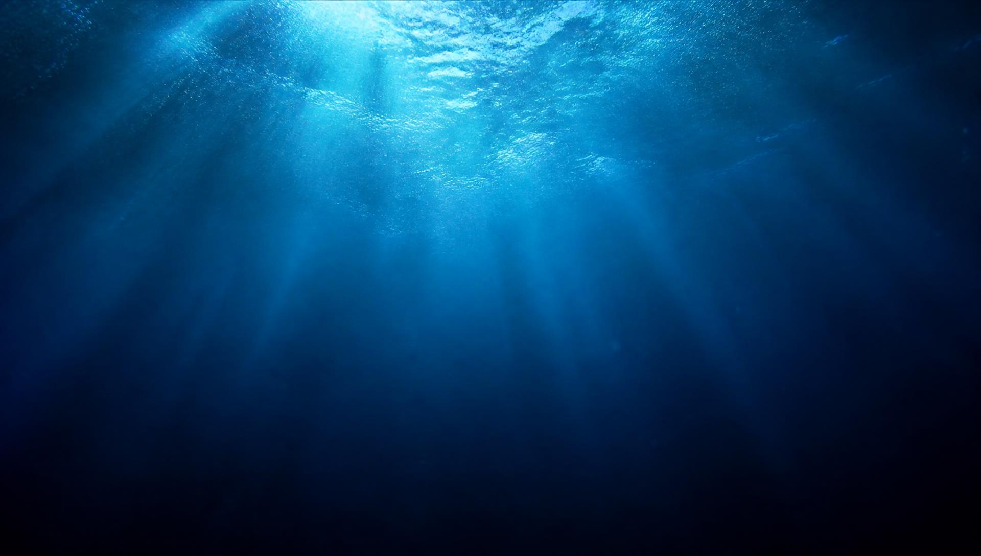 Light refracting through deep sapphire water